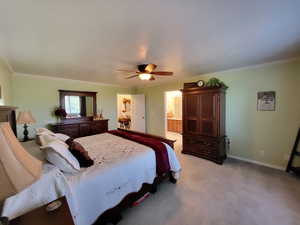 Bedroom featuring crown molding, light colored carpet, ceiling fan, and connected bathroom