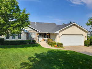 Single story home with a front lawn and a garage