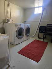 Washroom with washer and clothes dryer