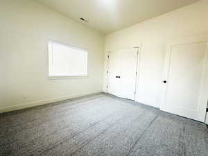 Unfurnished bedroom featuring a closet and carpet floors