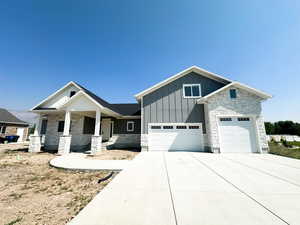 View of front of house featuring covered porch and a garage