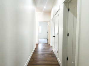 Hall with dark hardwood / wood-style flooring