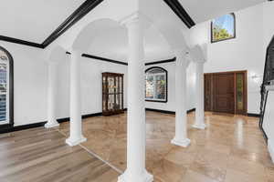 Entryway featuring light hardwood / wood-style floors and ornamental molding