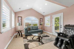 Sitting area off primary bedroom suite with entrance to private balcony