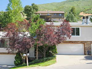 View of front facade with a mountain view and a garage