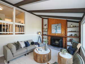 Living room with light colored carpet and lofted ceiling with beams