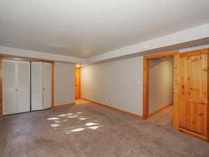 Unfurnished bedroom featuring a closet and light carpet