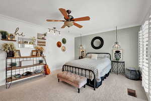 Bedroom featuring crown molding, carpet, and ceiling fan