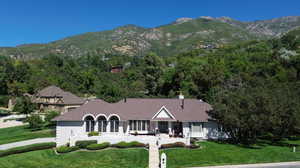 View of front facade featuring a front lawn and a mountain view