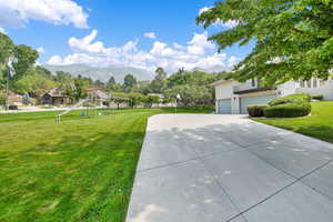 Exterior space with a garage, a mountain view, and a playground