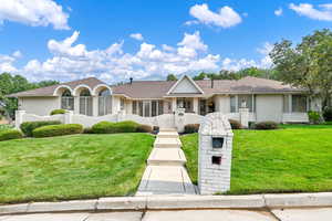 Ranch-style home featuring a front yard