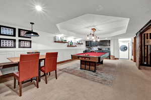 Rec room featuring light colored carpet, indoor bar, and pool table