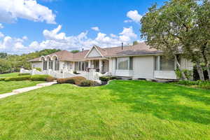 Ranch-style house with a front lawn