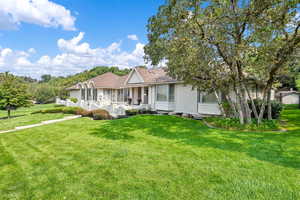 Single story home featuring a front lawn