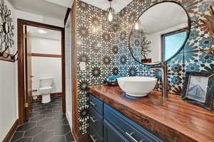 Bathroom with vanity, toilet, and tile patterned floors