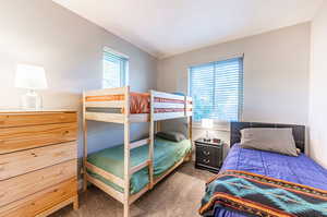 Carpeted bedroom with multiple windows