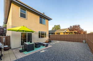 Rear view of house with a patio area.*Fence to be painted by HOA in 2025