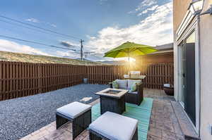 View of patio / terrace featuring a fire pit.*Fence to be painted by HOA in 2025