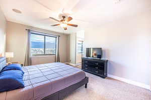 Carpeted bedroom with ceiling fan