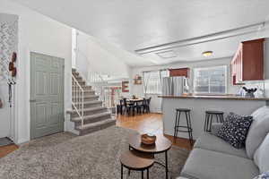 Living room featuring a textured ceiling, and light tile patterned flooring