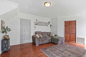 Living room with crown molding and dark hardwood / wood-style floors