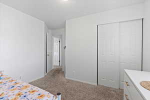 Bedroom featuring a closet and light carpet