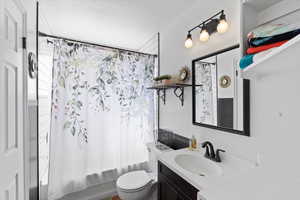 Full bathroom with shower / bath combination with curtain, toilet, and vanity