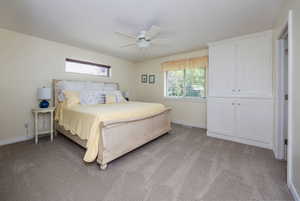 Unfurnished bedroom with a closet, ceiling fan, and light carpet