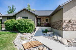 Doorway to property with a yard