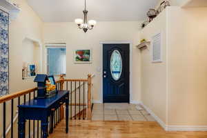 Foyer featuring hardwood / wood-style flooring and a notable chandelier