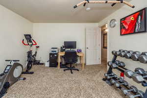 Carpeted office featuring a textured ceiling