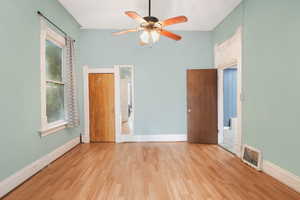 1 bedroom with light wood-type flooring and ceiling fan