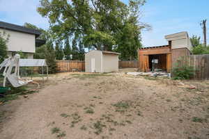 View of yard featuring a storage unit