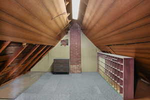 Bonus room featuring lofted ceiling, wood walls, and wood ceiling