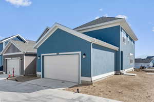 View of back of property with a garage