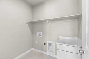 Laundry room featuring hookup for a washing machine, light tile patterned floors, and hookup for an electric dryer