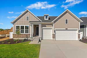 Craftsman-style rambler home with a 3-car garage and front landscaping