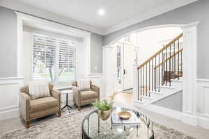 Sitting room featuring crown molding and light hardwood / wood-style floors