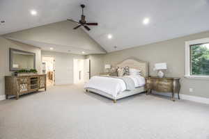 Carpeted bedroom featuring high vaulted ceiling and ceiling fan