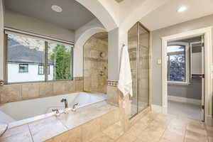 Bathroom featuring tile patterned flooring and shower with separate bathtub