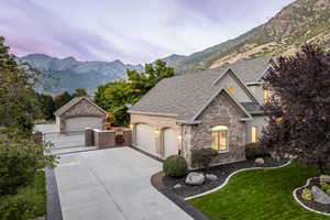 French provincial home with a yard, a garage, and a mountain view