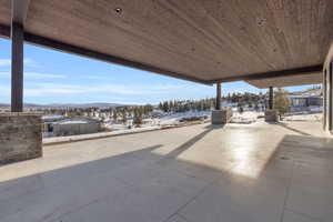 Snow covered patio with a mountain view