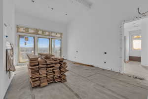 Living room with beamed ceiling and high vaulted ceiling