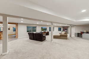 Living room featuring light carpet and decorative columns