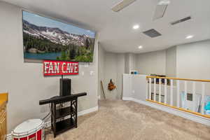 Loft with ceiling fan and built-ins