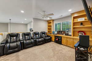 Loft with ceiling fan and built-ins