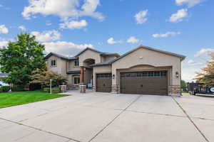 View of front of home with a front lawn and a garage