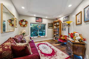 Office featuring hardwood / wood-style floors and a raised ceiling