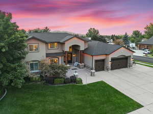 View of front of house with a yard and a garage