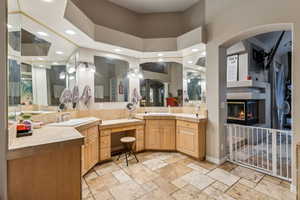 Primary Bathroom with a high ceiling, mirrors and vanity